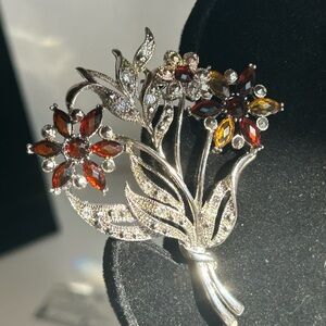 Silver-tone brooch with amber colored and clear rhinestones flower bouquet